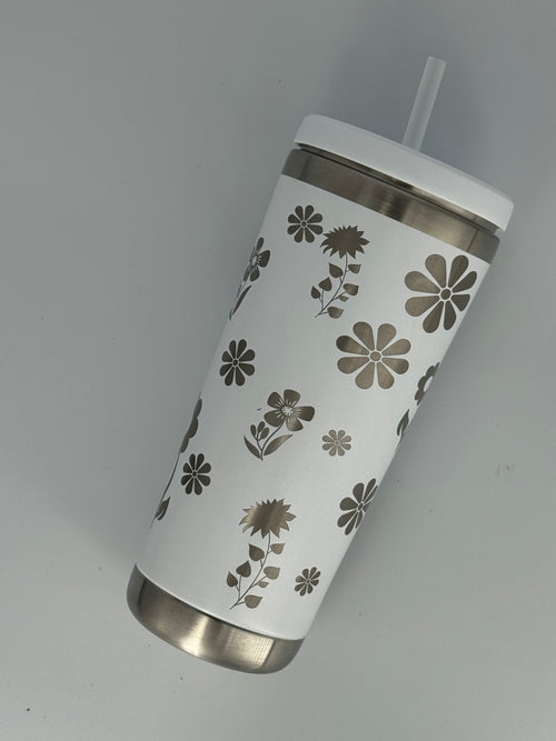 White stainless steel tumbler with laser-engraved floral design featuring daisies, sunflowers, and wildflowers, with lid and straw