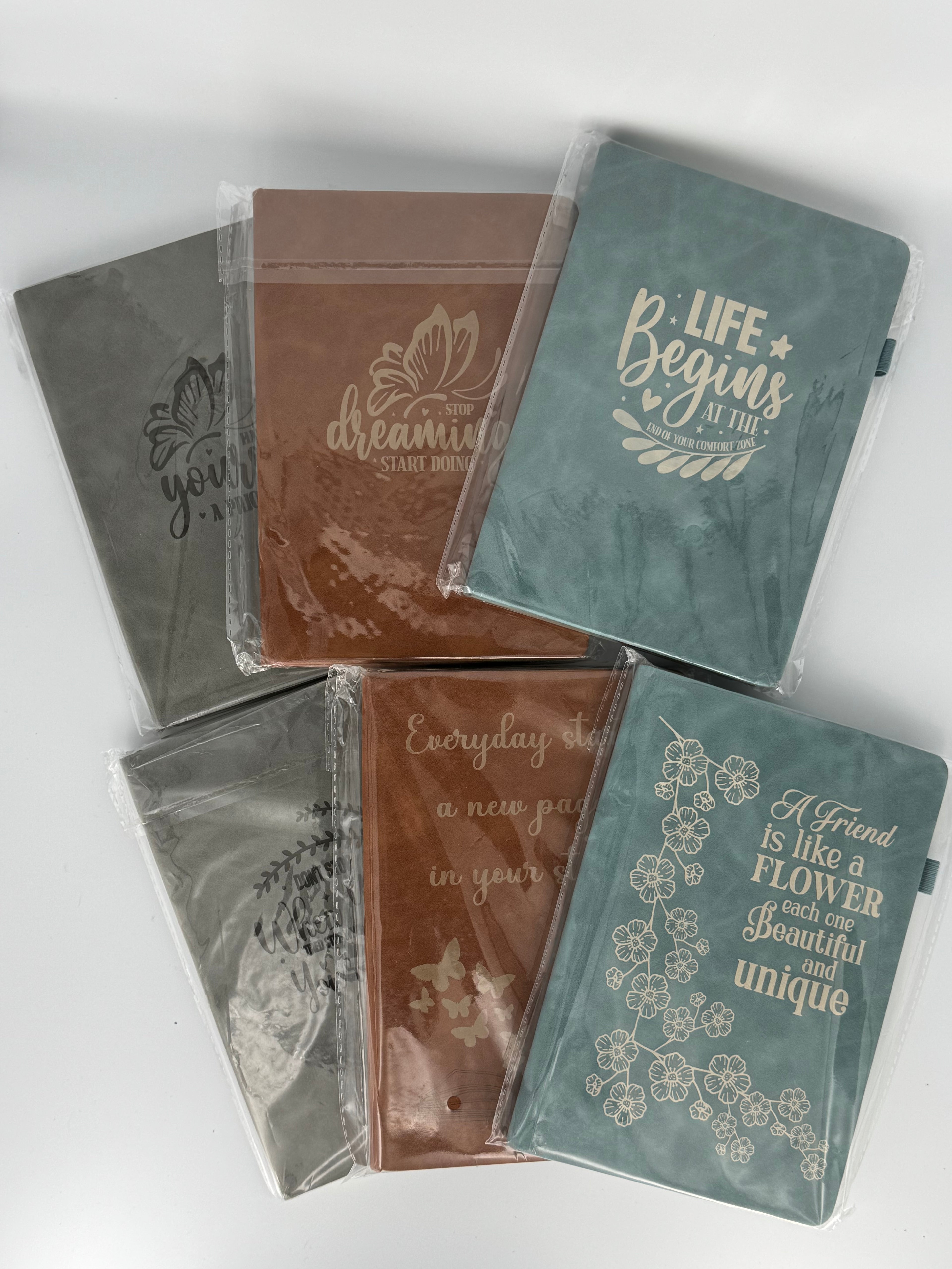 Laser engraved faux leather journals with inspirational quotes in gray and brown