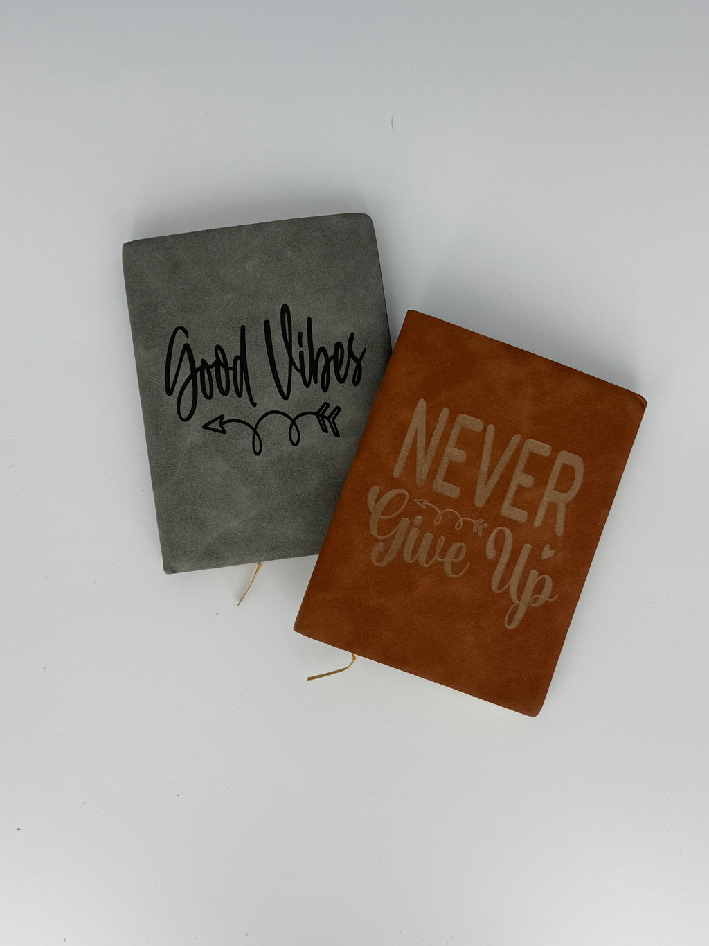Small laser engraved faux leather journals with motivational designs