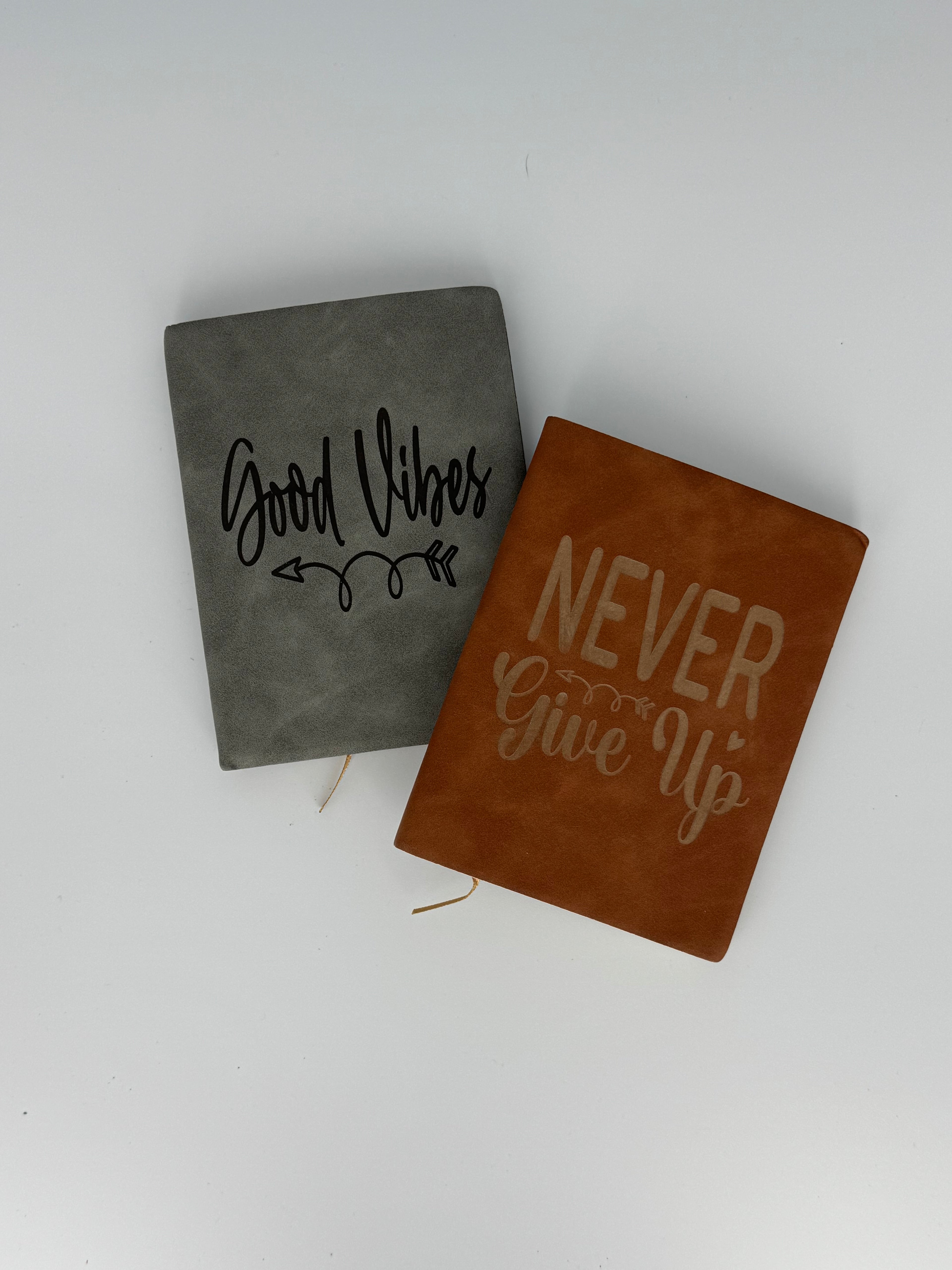 Small laser engraved faux leather journals with motivational designs