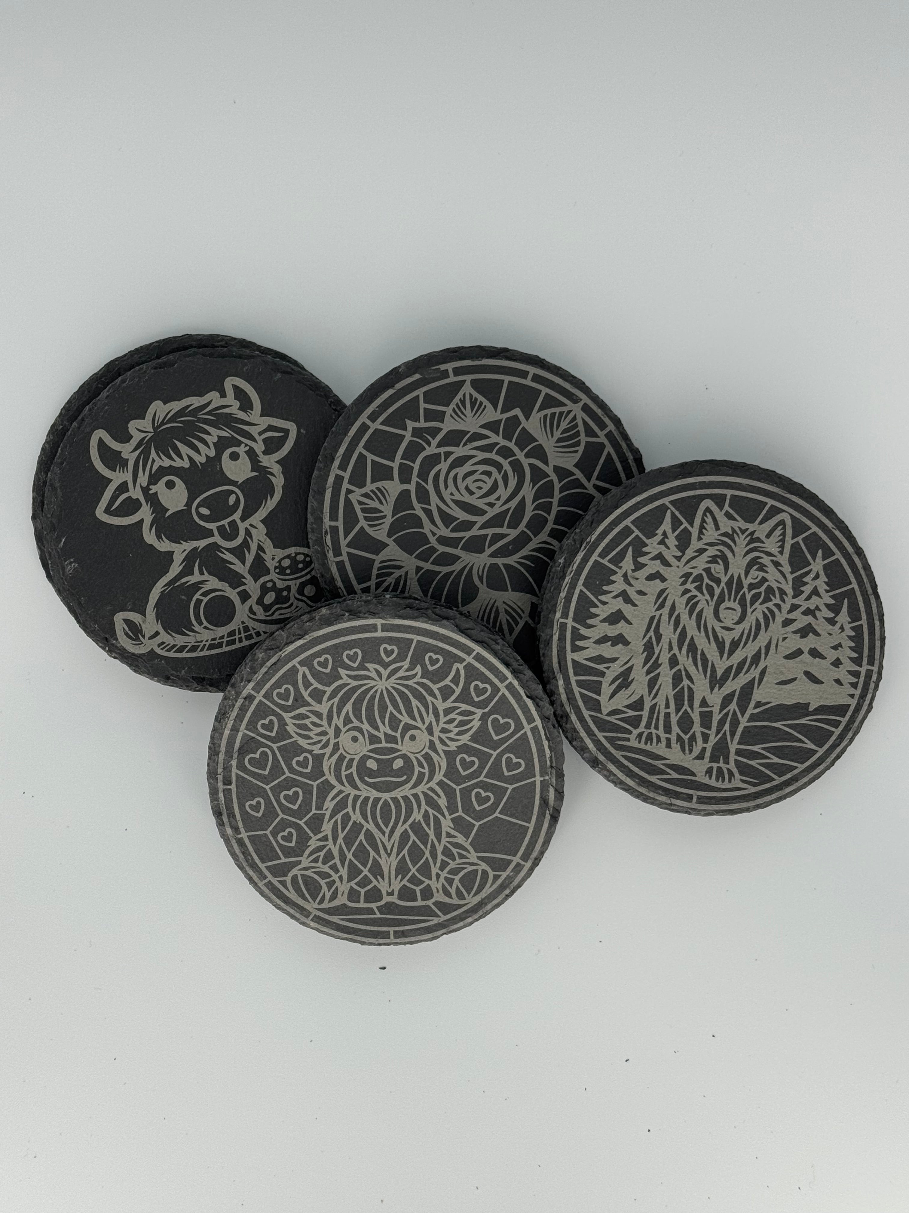 Laser engraved slate coasters with highland cow, wolf, and rose designs